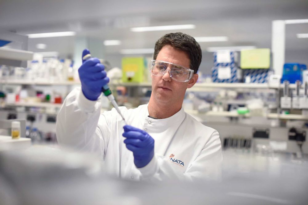 NATA scientist pipetting in a laboratory 