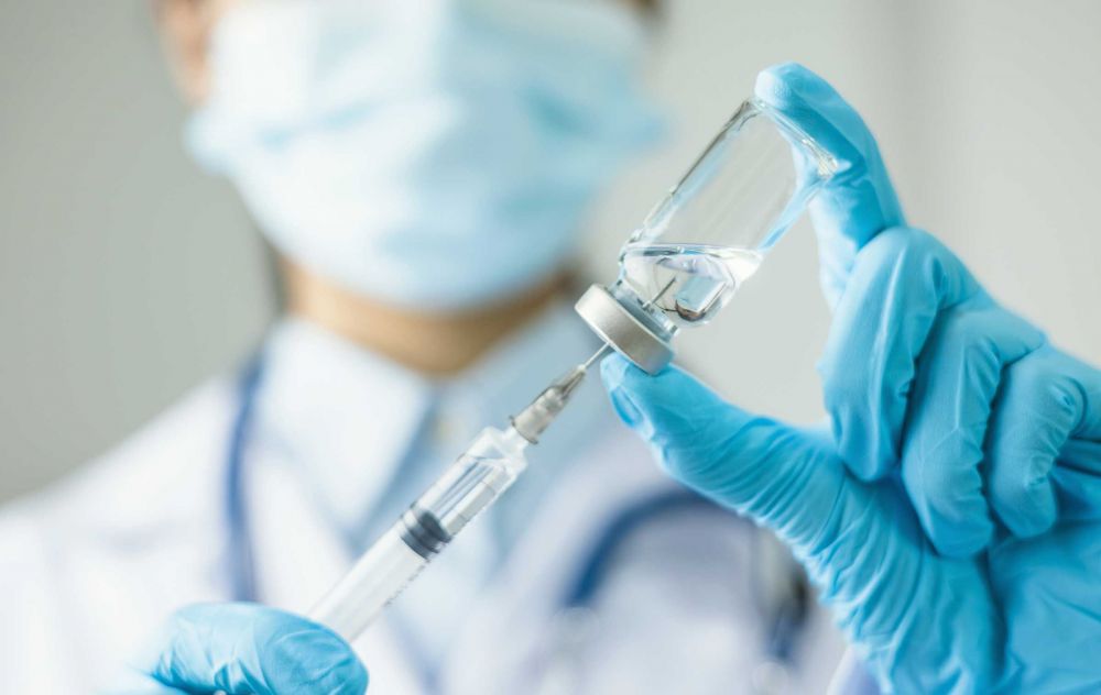 Doctor holding a syringe and vial